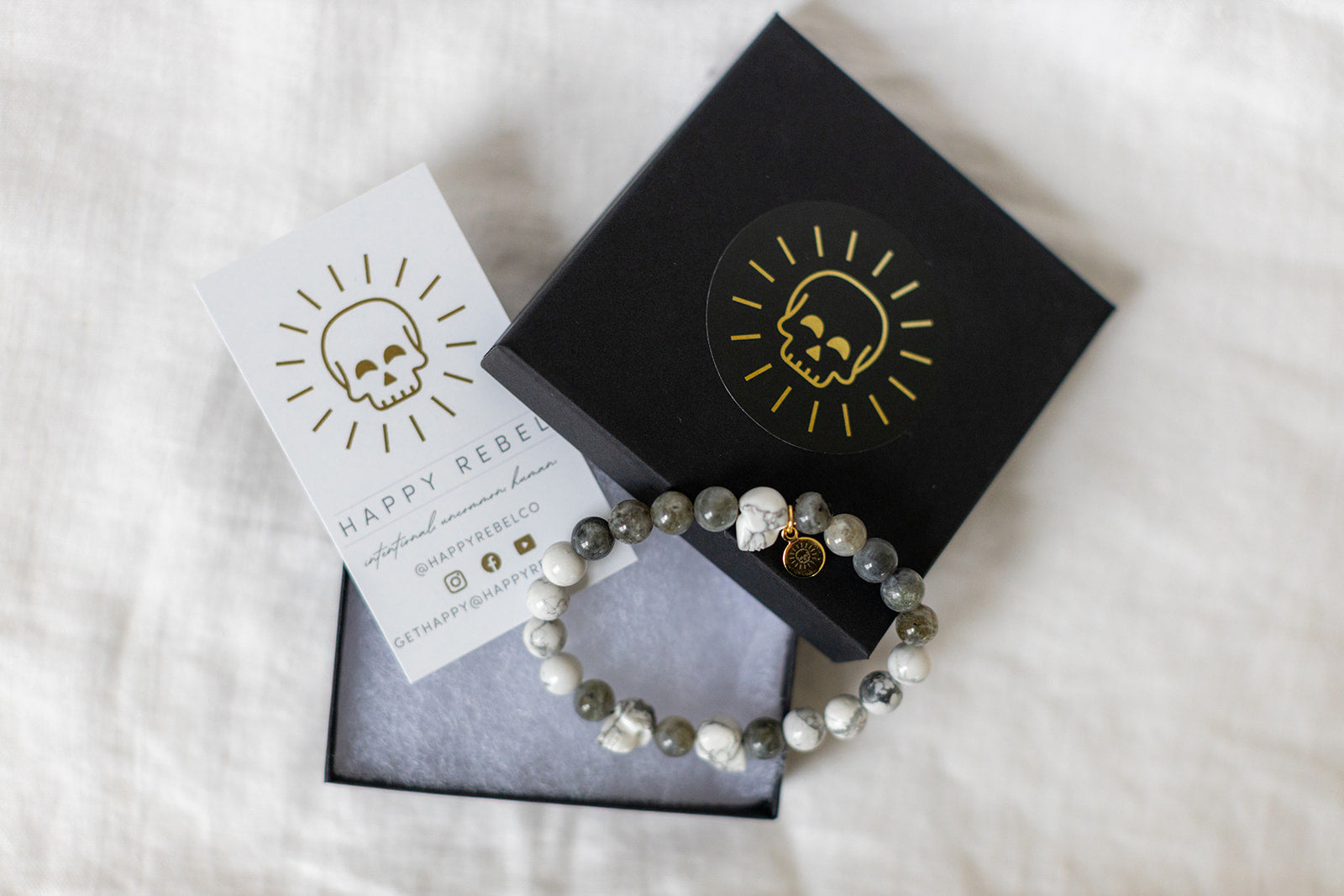 Happy Rebel box, bracelet, and card.