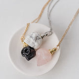 three crystal skull necklaces