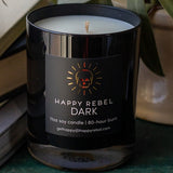Happy Rebel Dark candle on a shelf